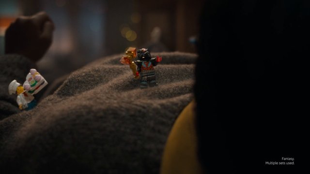 Video Reference: toy figures, close-up, miniature, indoor, warm lighting, blurred background, fantasy, small objects, play scene, figurines, textured surface, dollhouse, collectible toy, low light
