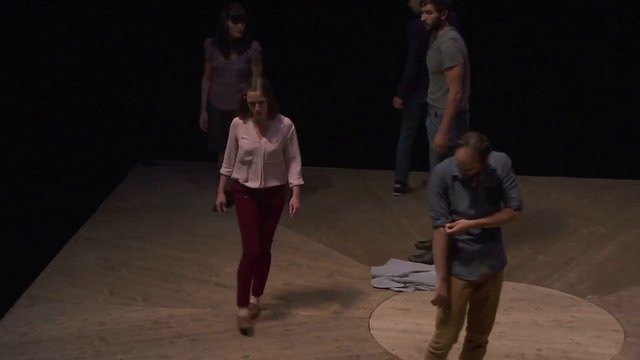 Video Reference: people, stage, performance, theater, indoor, wooden floor, dark background, group, standing, walking, low light, rehearsal