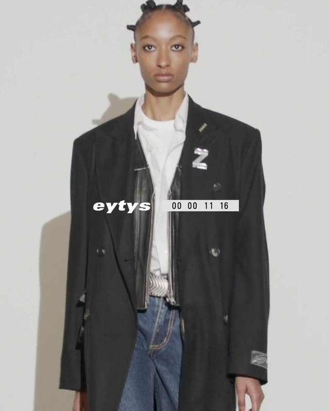 Video Reference: Face, Arm, Dress shirt, Neck, Sleeve, Waist, Street fashion, Jacket, Collar, Grey