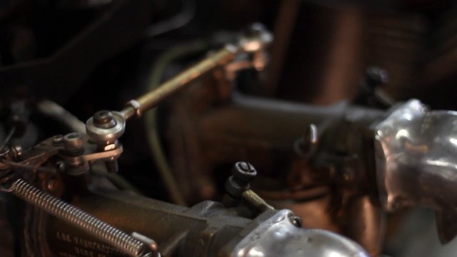 Video Reference: mechanical, machinery, metal, close-up, industrial, components, spring, rod, bolt, engineering, hardware, detail, low-light, shallow-focus