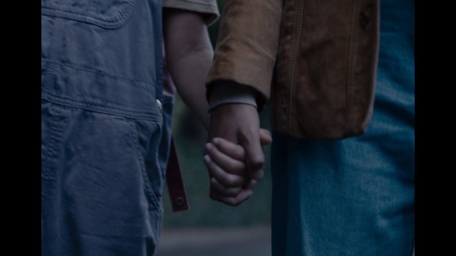 Video Reference: handholding, couple, outdoors, close-up, waist-down, jacket, denim, relationship, togetherness, romance, blurred-background