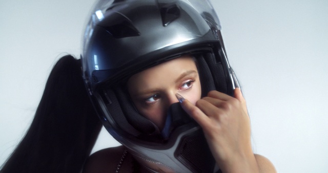 Video Reference: Face, Head, Helmet, Sports gear, Equestrian helmet, Motorcycle helmet, Gesture, Headgear, Cap, Personal protective equipment