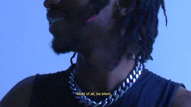 Video Reference: Black, Music artist, Music, Facial hair, Musician, Electric blue, Entertainment, Audio equipment, Performing arts, Event