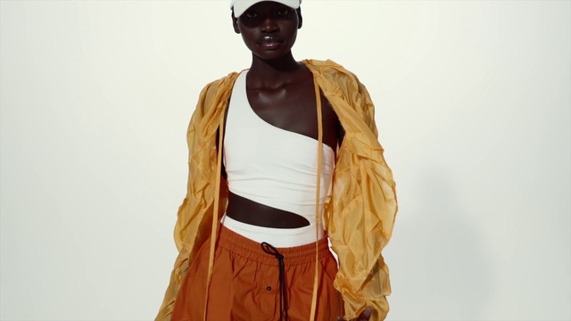 Video Reference: Arm, Shoulder, Human body, Neck, Sleeve, Street fashion, Waist, Baseball cap, Fashion design, Headgear