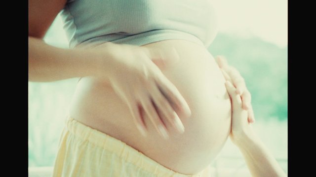 Video Reference: pregnancy, pregnant belly, belly rub, hands, close-up, human body, motherhood, expecting, care, wellness, natural light, indoors, soft focus, tender moment