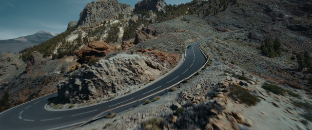 Video Reference: Mountain, Slope, Plant, Sky, Road surface, Bedrock, Tree, Asphalt, Thoroughfare, Landscape