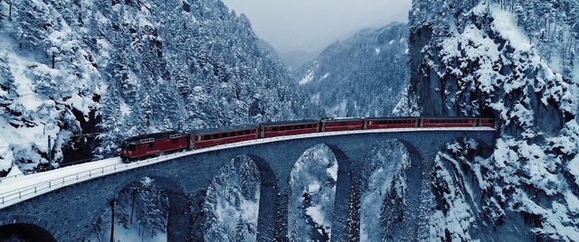 Video Reference: Train, Mountain, Snow, Sky, Plant, Tree, Vehicle, Slope, Rolling stock, Highland