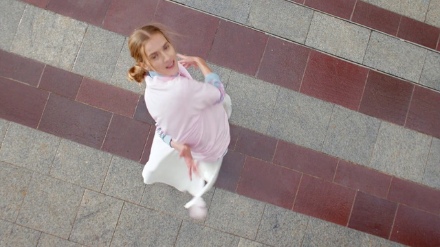 Video Reference: Hair, Leg, Sleeve, Street fashion, Flooring, Pink, Floor, Waist, Road surface, Thigh