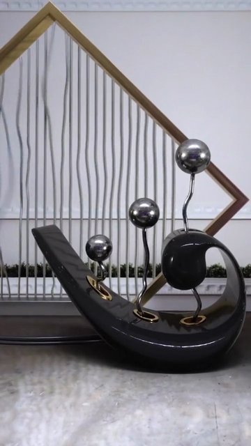 Video Reference: sculpture, decorative, abstract, tabletop, metal, spheres, modern, art, home decor, indoor, geometric, black, silver, ornament, still life