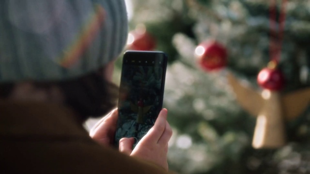 Video Reference: Christmas tree, Plant, Gesture, Mobile phone, Tartan, Finger, Communication Device, Portable communications device, Tree, Gadget