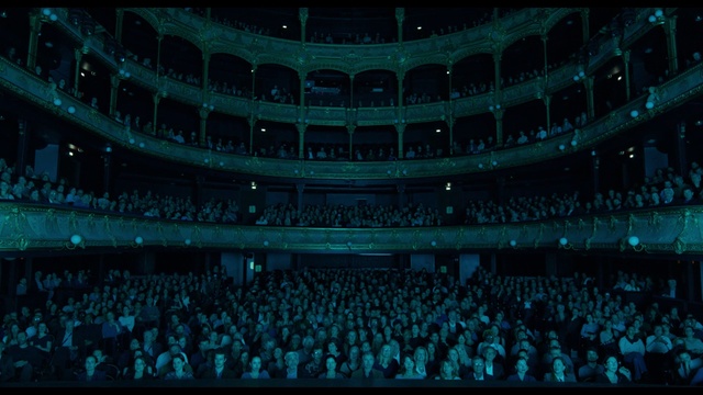 Video Reference: Building, Blue, Entertainment, Performing arts, Event, Performing arts center, Crowd, Concert hall, Projection screen, Display device