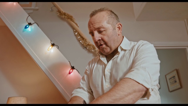 Video Reference: Gesture, Flash photography, Beard, Wood, Audio equipment, Facial hair, Event, Elbow, Light bulb, T-shirt