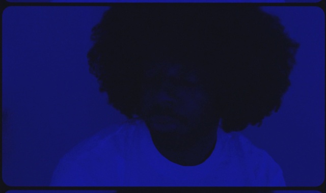 Video Reference: Azure, Flash photography, Jaw, Gesture, Beard, Font, Eyewear, Tints and shades, Electric blue, Facial hair