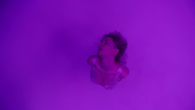 Video Reference: Head, Purple, Human body, Flash photography, Gesture, Violet, Magenta, Electric blue, Petal, Art