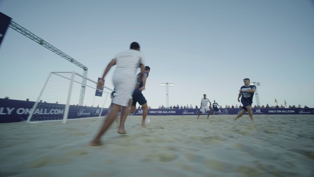 Video Reference: Sky, Shorts, Active shorts, People on beach, Volleyball net, Sports equipment, Net sports, Trunks, Gesture, Barefoot