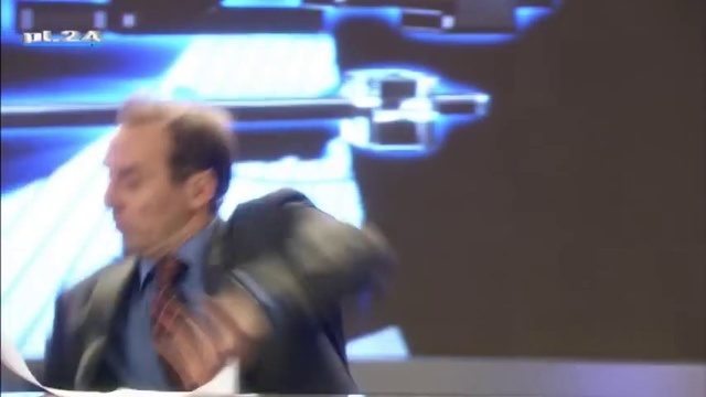 Video Reference: Coat, Gesture, Entertainment, Blazer, Suit, Display device, Tie, Event, Television program, Fun