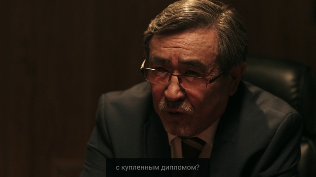 Video Reference: Forehead, Glasses, Chin, Eyebrow, Vision care, Microphone, Coat, Flash photography, Suit, Audio equipment