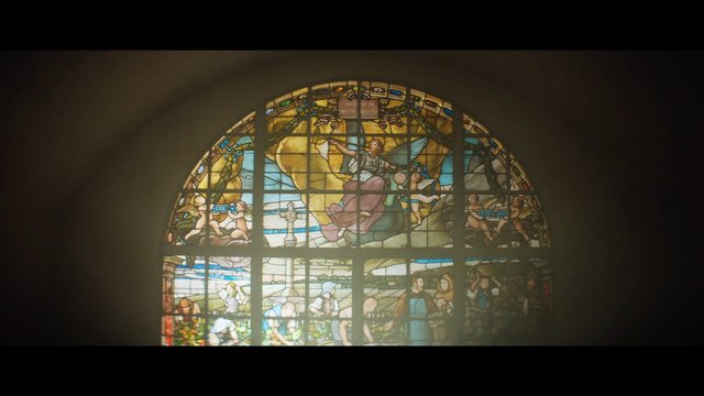 Video Reference: stained glass, church window, religious art, arched window, interior, cathedral, vitrail, angel, figure, historic, colorful glass, backlit, architecture, decorative, sacred