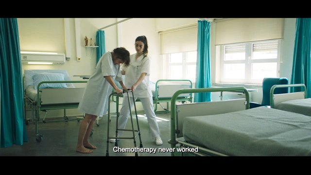 Video Reference: hospital, patient, walker, nurse, caregiver, recovery, bedroom, medical, assistance, indoor, healthcare, ward, female, standing, subtitle, clinic
