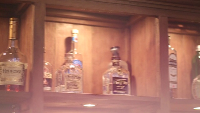 Video Reference: Brown, Bottle, Drinkware, Barware, Glass bottle, Fluid, Drink, Alcoholic beverage, Wood, Liquid