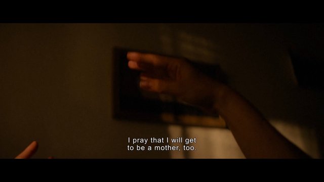 Video Reference: dimly lit, close-up, hand, gesture, indoor, subtitle, dark scene, wall, motion blur, cinematic, low light