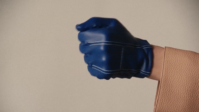 Video Reference: Glove, Sports gear, Safety glove, Human body, Sleeve, Gesture, Finger, Thumb, Personal protective equipment, Electric blue