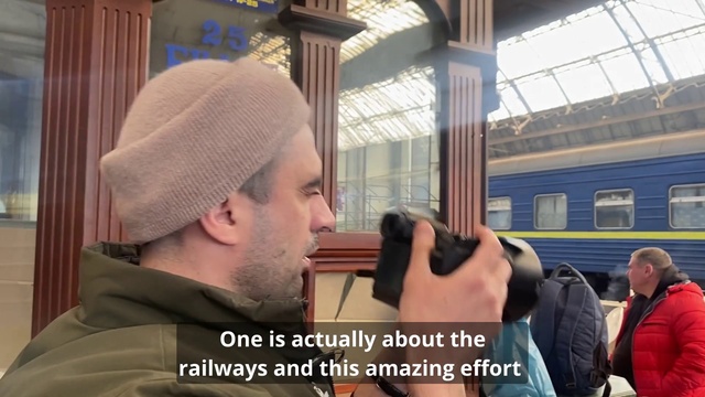 Video Reference: Train, Cap, Beard, Travel, Public transport, Event, Rolling stock, Moustache, Knit cap, Facial hair