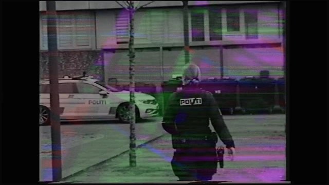 Video Reference: police, officer, street, snow, residential, houses, parked cars, winter, walking, outdoors, uniform, neighborhood, surveillance, glitch, video noise