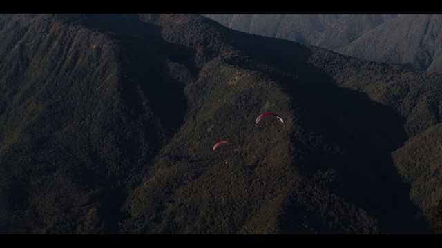 Video Reference: Mountain, Slope, Sky, Terrain, Landscape, Mountain range, Hill, Air travel, Parachute, Ridge