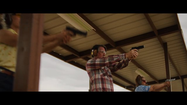 Video Reference: shooting range, handgun, pistol, target practice, firearm, outdoor, training, safety glasses, ear protection, covered range, sport shooting, people, action