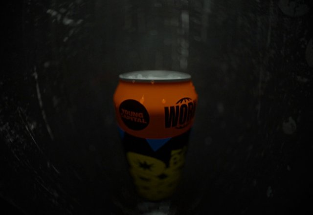 Video Reference: beverage can, close-up, dark, metallic, orange, product, container, tunnel, reflection, studio lighting, abstract, packaging