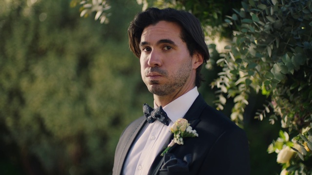 Video Reference: Face, Hair, Beard, Dress shirt, Plant, Flash photography, Tie, Collar, Happy, Blazer