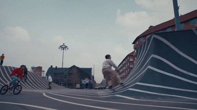 Video Reference: Sky, Cloud, Building, Asphalt, Rolling, Skatepark, Jacket, Tree, Street light, Automotive tire