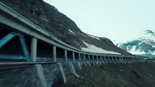 Video Reference: Sky, Slope, Road, Bridge, Mountain, Reservoir, Cloud, Dam, Mountain range, Concrete bridge
