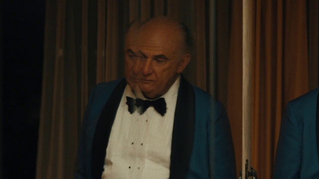 Video Reference: Bow tie, Dress shirt, Collar, Blazer, Formal wear, Curtain, Event, Official, Uniform, Elder