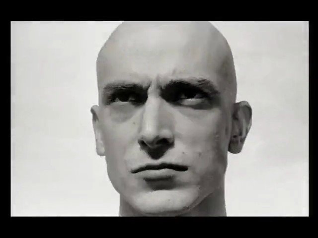 Video Reference: black_and_white, close_up, mannequin, head, face, bald, studio, portrait, neutral_background, sculpture, facing_camera