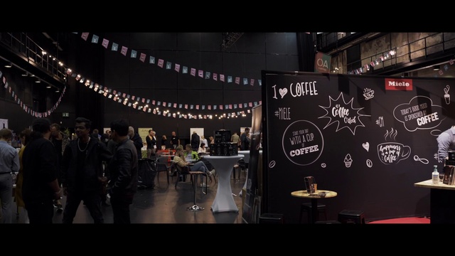 Video Reference: Entertainment, Automotive design, Table, Stage, Event, Chair, Flooring, Audio equipment, Darkness, Suit