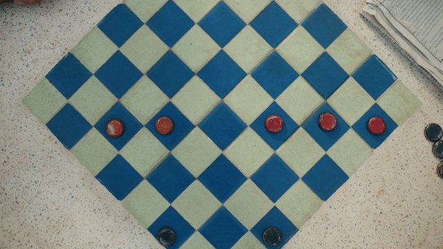 Video Reference: checkers, board game, game board, game pieces, top view, pattern, tiles, blue, red, indoor, strategy, tabletop, abstract, newspaper