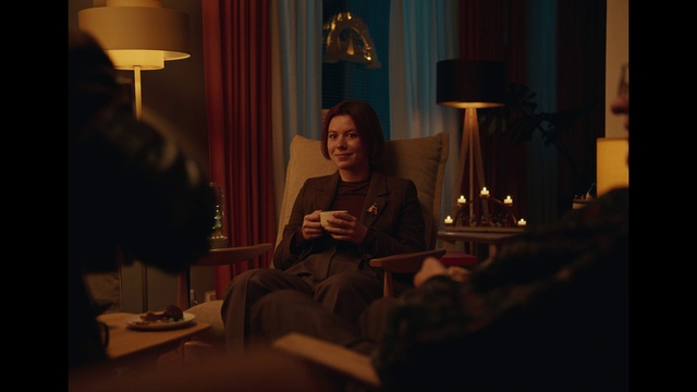 Video Reference: Lamp, Lighting, Comfort, Interior design, Smile, Picture frame, Tints and shades, Living room, Curtain, Facial hair