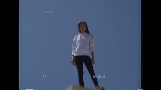 Video Reference: Sky, Flash photography, Sleeve, Gesture, Happy, Recreation, Electric blue, Balance, Monument, Sitting