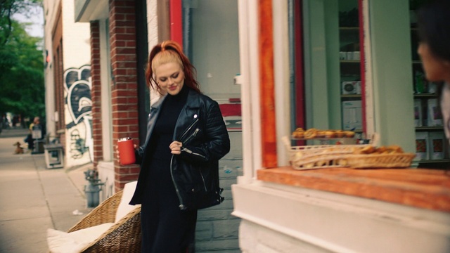 Video Reference: Fashion, Street fashion, Standing, Luggage and bags, Jacket, Travel, City, Handbag, Sidewalk, Facade