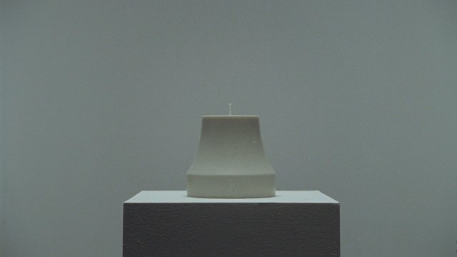 Video Reference: candle, pedestal, minimalism, still life, product shot, gray background, studio lighting, object, centered, simple, abstract