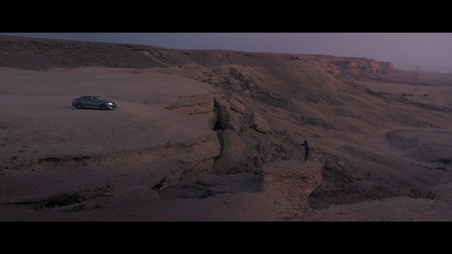 Video Reference: Automotive tire, Tire, Motor vehicle, Landscape, Tints and shades, Aeolian landform, Vehicle, Horizon, Bedrock, Plateau