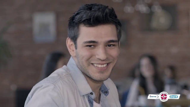 Video Reference: Forehead, Smile, Hairstyle, Human, Flash photography, Jaw, Dress shirt, Eyelash, Sleeve, Microphone