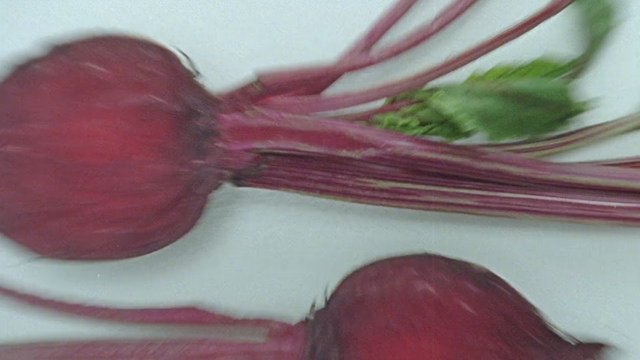 Video Reference: beet, beets, root vegetable, vegetable, produce, fresh, organic, greens, stems, close-up, food, raw, harvest, market, cooking, motion blur