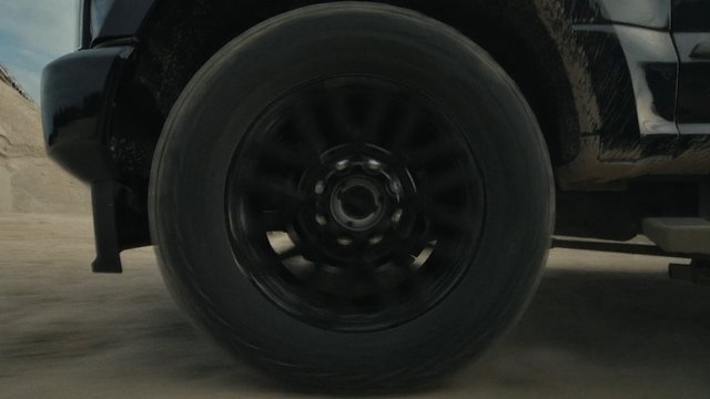 Video Reference: car, wheel, tire, spinning, motion blur, vehicle, road, close-up, transportation, automotive, black car, driving
