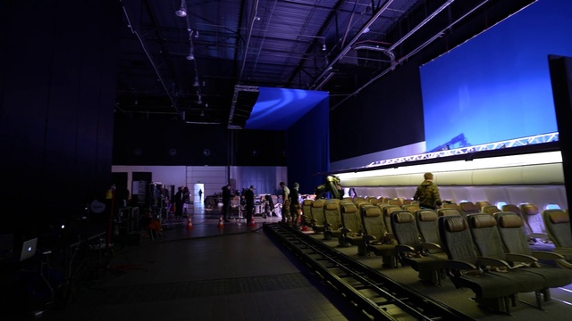 Video Reference: Chair, Entertainment, Event, Performing arts center, Electric blue, Crowd, Audience, Display device, Stage, Hall