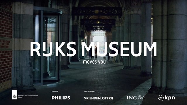 Video Reference: museum, corridor, arches, stone columns, indoor, historic building, people, promotional text, signage, Rijksmuseum, architecture, hallway, tourism, ad