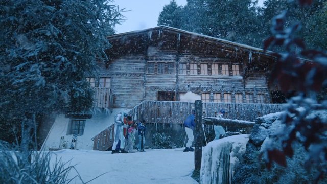 Video Reference: snow, winter, cabin, wooden house, trees, icicles, people, skiing, resort, outdoor, cold, mountain, snowy landscape, stairs, balcony