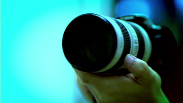 Video Reference: camera, DSLR, lens, telephoto, photography, close-up, hand, equipment, vintage, blue tint, portrait orientation, optics